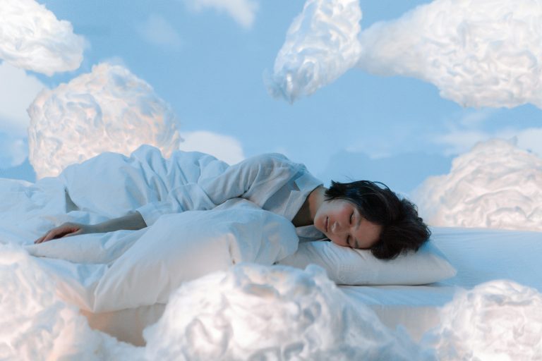 Woman sleeping peacefully on cloud-like bedding from Cuddles Singapore